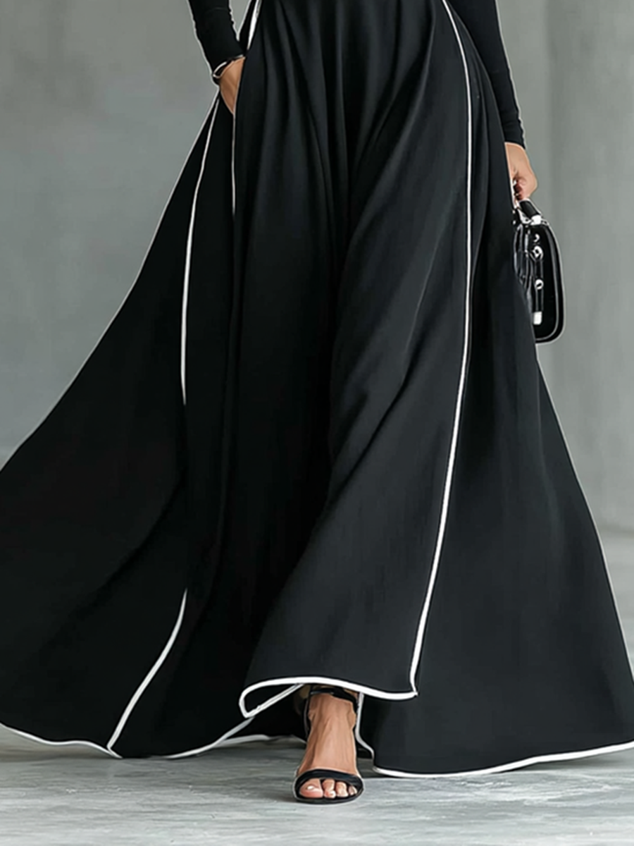 Gina – Vestido maxi de mujer negro con costuras blancas y cuello alto, mangas largas y cintura entallada